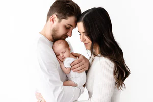 Mother and father holding their newborn baby during a family newborn photography session
